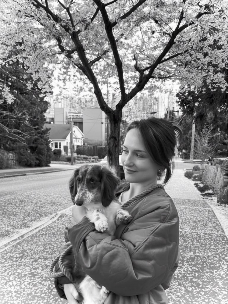 Jenna Ammerall holding Maeve, her dachshund, outdoors in Seattle