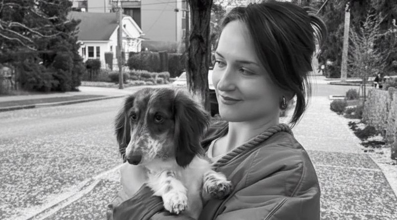 Jenna Ammerall holding Maeve, her dachshund, outdoors in Seattle